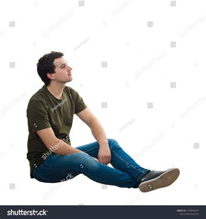 a man sitting down with his hands crossed