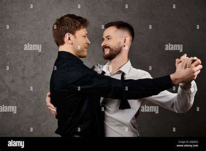 Gay Couple Dancing And Kissing At Party Stock Photo Download Image