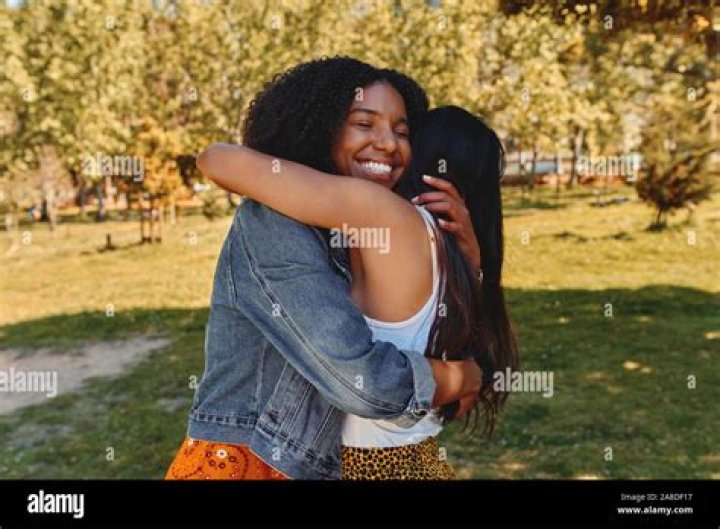 two women hugging each other at a party